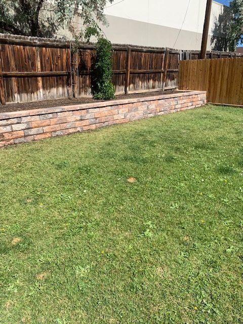 Retaining wall made of pavers with bush