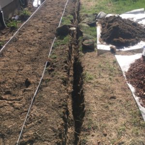 Trench being dug for french drain